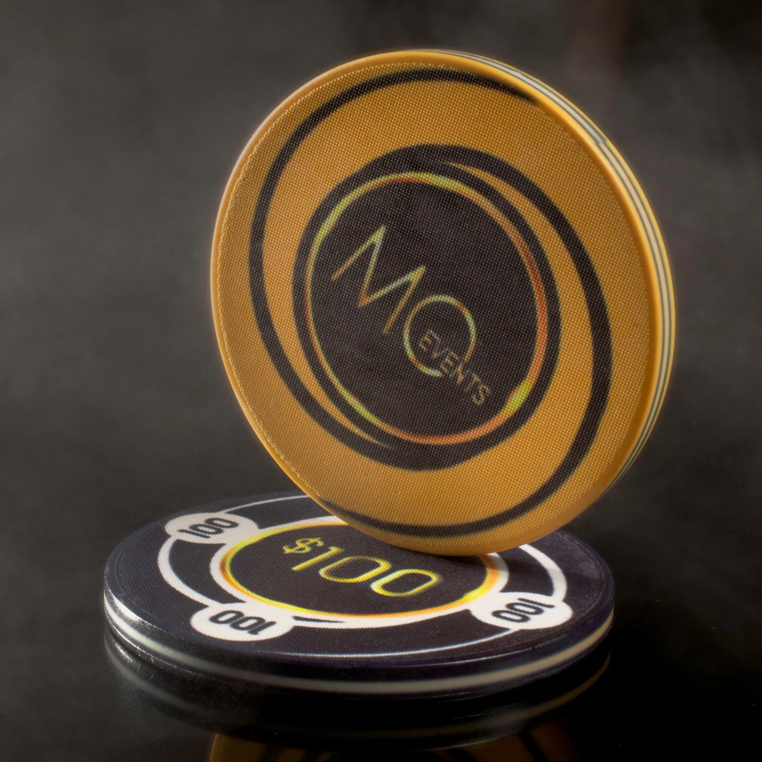 Two custom poker chips for MO Events stacked artistically.